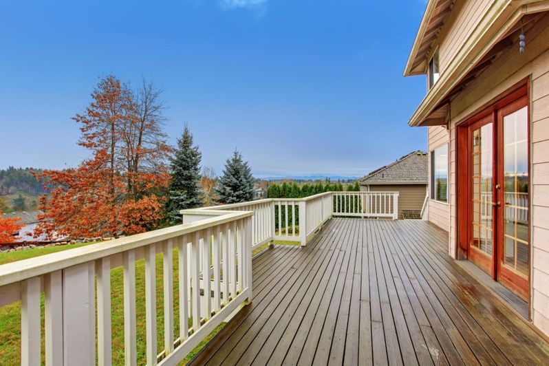 a large deck with a view of a lake.