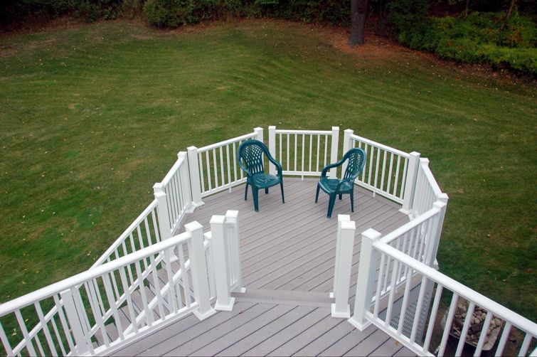 Two green chairs on a composite deck.