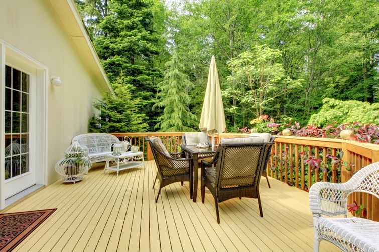 A deck adorned with chairs and an umbrella made of wood." (Keywords: deck, wood)