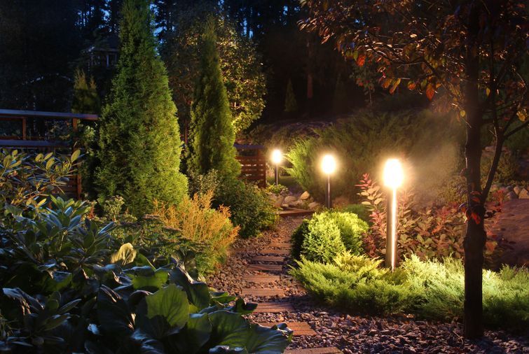 A cost-effective landscape pathway illuminated by three lights at night.