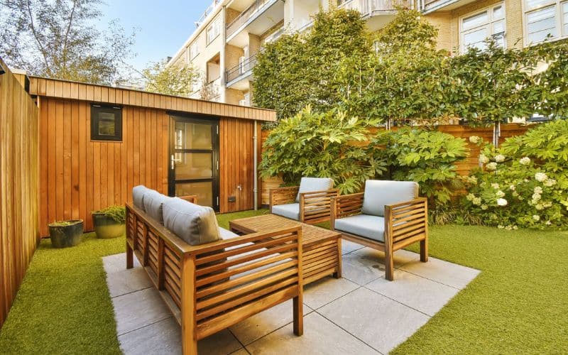 a backyard with Wooden Garden Furniture