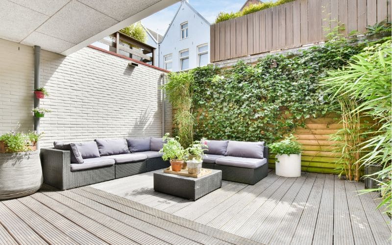 A Patio With Couches And Plants On A Deck