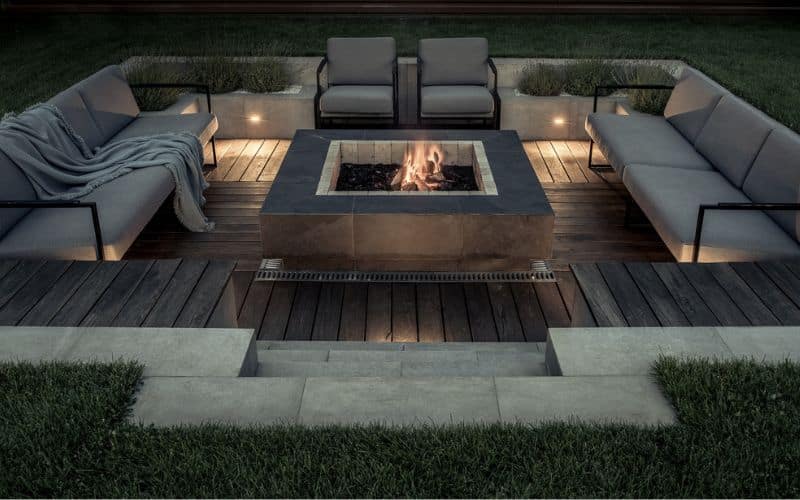 a fire pit sitting on top of a wooden deck.