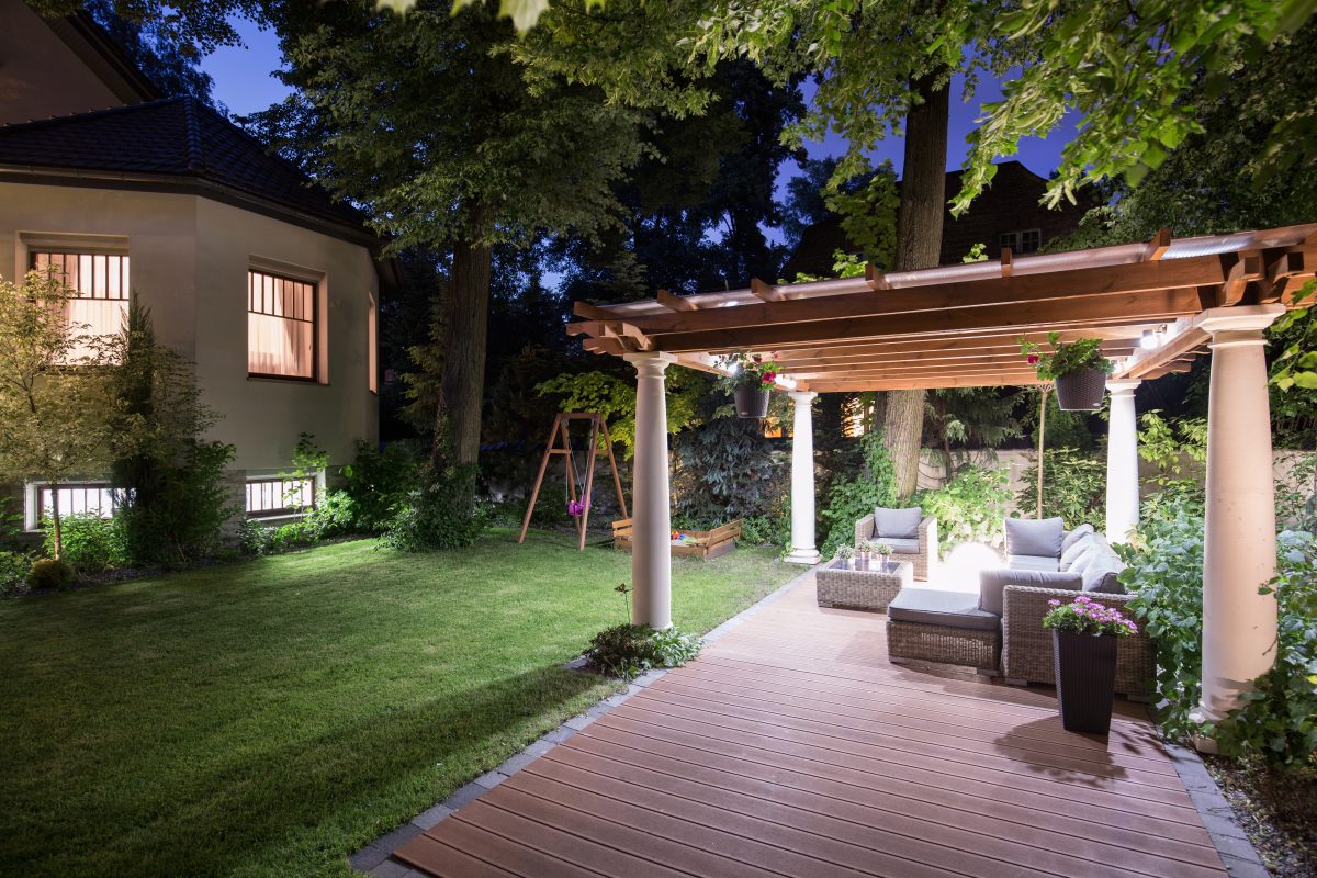 a backyard with a covered patio and seating area.
