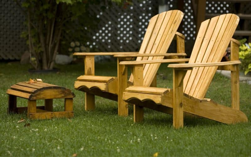 A pair of wooden adirondack chairs 