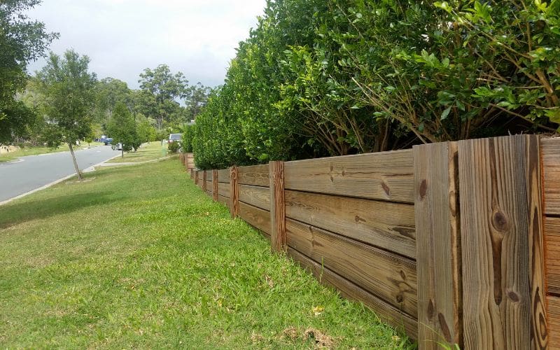 A timber wall next to a lawn.