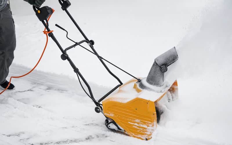 Using a snowblower on a composite deck with careful technique to prevent scratches.