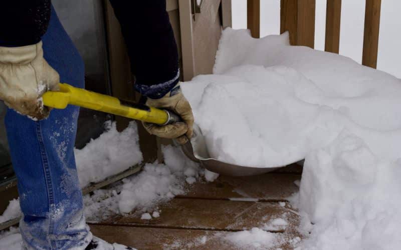Tools like shovels and snow pushers designed for safe snow removal from composite decks.